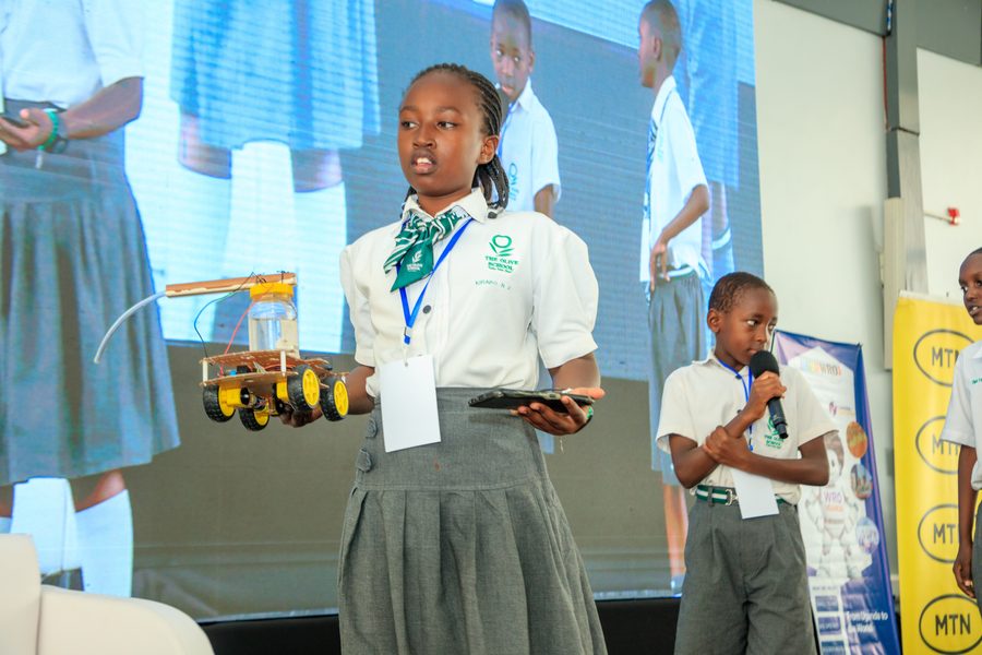 A student presenting her robot to a teammate at the Uganda National Championship